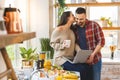 Young couple using laptop to look up recipe for their meal in kitchen Royalty Free Stock Photo