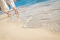 Young loving couple walking by tropical beach Royalty Free Stock Photo
