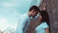 Young loving couples standing next to the brick wall, happy and satisfied Royalty Free Stock Photo