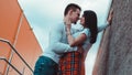 Young loving couples standing next to the brick wall, happy and satisfied Royalty Free Stock Photo