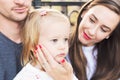 Young loving family of three, authentic candid outdoors family portrait Royalty Free Stock Photo