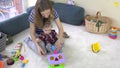 Young loving mom teaches daughter girl to distinguish object shapes.