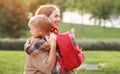 Young loving mother hugging embracing little son schoolboy before first day in school