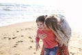 Young loving mother with smiling daughter running towards her on sunny beach Royalty Free Stock Photo