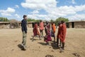 Young Maasai Askari doing a traditional jumping dance with tourist