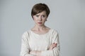 Young mad angry and upset red hair woman posing sad and moody looking to camera isolated on grey background in facial expressions Royalty Free Stock Photo