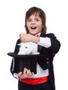 Young magician boy taking a rabbit out of his hat Royalty Free Stock Photo