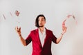 Young magician juggling a deck of playing cards