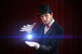 Young magician man is showing bright ball that levitates Royalty Free Stock Photo