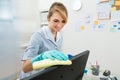 Young maid cleaning computer Royalty Free Stock Photo