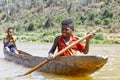 Young Malagasy african boy rowing traditional canoe Royalty Free Stock Photo