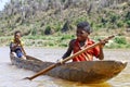 Young Malagasy african boy rowing traditional canoe Royalty Free Stock Photo