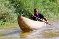 Young Malagasy rafter man rowing traditional canoe