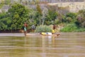 Young Malagasy rafter man rowing traditional canoe