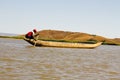 Young Malagasy rafter man rowing traditional canoe