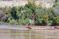 Young Malagasy rafter man rowing traditional canoe