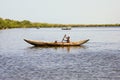 Young Malagasy rafter man rowing traditional canoe