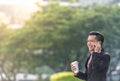 Young Malay Business Man on his Smartphone on his coffee break