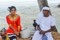 Young maldivian couple dressed in national clothes cooking breakfast