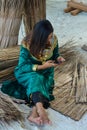 Young maldivian girl in national clothes playing with mobile phone