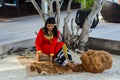 Young maldivian girl in red national clothes working on crude