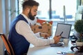 Young male accountant working on laptop