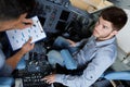Young male aero engineer with clipboard working in cockpit Royalty Free Stock Photo