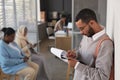 Young male applicant filling in visa application form in front of camera