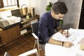 A young male architect working on a project in his office in Lisbon, Portugal. Young man working smart using the desktop computer