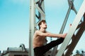 Young male athlete performing stretching exercises for back and arms in an urban place Royalty Free Stock Photo