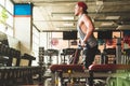 young male athlete performs exercises in the gym with dumbbells. Endurance Strength Training