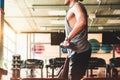 young male athlete performs exercises in the gym with dumbbells. Endurance Strength Training