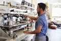 Young male barista preparing espresso at a coffee shop Royalty Free Stock Photo