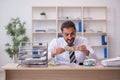 Young male bookkeeper in budget planning concept Royalty Free Stock Photo