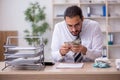 Young male bookkeeper in budget planning concept Royalty Free Stock Photo