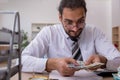 Young male bookkeeper in budget planning concept Royalty Free Stock Photo