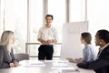 Young male boss make flip chart presentation for company clients Royalty Free Stock Photo