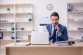 Young male businessman employee working in the office Royalty Free Stock Photo