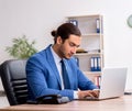 Young male businessman employee working in the office Royalty Free Stock Photo