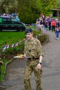 A Young Male Cadet in Uniform Carrying a Tray of Delicious Cakes at King Charles III's Coronation Event in Harrogate, UK.