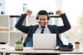 Another win in the bag. a young male call center agent cheering while using a laptop in an office at work. Royalty Free Stock Photo