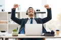 Success is never far away. a young male call center agent cheering while using a laptop in an office at work. Royalty Free Stock Photo