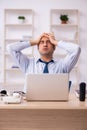 Young male call center operator working at his desk Royalty Free Stock Photo