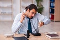 Young male call center operator working at his desk Royalty Free Stock Photo