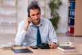 Young male call center operator working at his desk Royalty Free Stock Photo