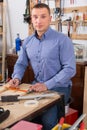 young male carpenter working wood plank at workshop Royalty Free Stock Photo