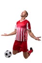 Young male caucasian soccer player celebrating goal by ball against white background Royalty Free Stock Photo