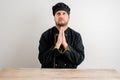 Young male chef in black uniform praying Royalty Free Stock Photo