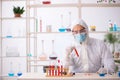 Young male chemist in drugs syntesis concept