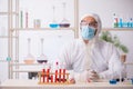 Young male chemist in drugs syntesis concept Royalty Free Stock Photo